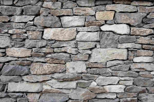 Decorative stone wall built with natural masonry for outdoor landscaping